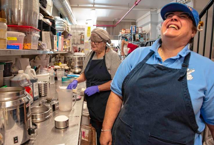 Judy Herrell laughing while making hot fudge